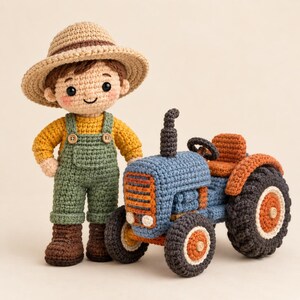 May include: A crocheted doll wearing a tan hat, yellow long-sleeve shirt, and green overalls with brown boots, standing next to a crocheted blue tractor with orange accents, a brown seat, and large black wheels with orange centres.
