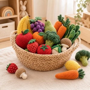 May include: A woven basket filled with various crocheted fruits and vegetables, including a yellow banana, purple grapes, a red apple, orange, strawberry, tomato, pear, carrots, broccoli, and mushrooms, with additional pieces placed outside the basket.