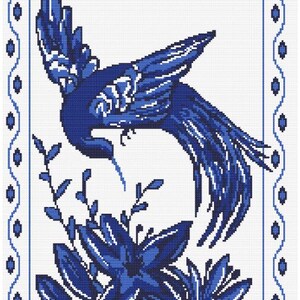 May include: A cross-stitch pattern featuring a blue bird in flight above a cluster of blue flowers. The design is enclosed within a rectangular border decorated with a repeating blue oval motif against a white background, rendered in a pixelated style.