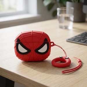 May include: A red silicone protective case for wireless earbuds featuring a raised black web pattern and white eye graphics. The case includes a matching red circular finger ring attachment connected by a thin red cord for easy carrying.