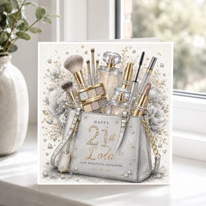 May include: A square greeting card featuring a silver handbag illustration filled with makeup brushes, perfume bottles, and lipstick. The text reads Happy 21st Lola Our Beautiful Daughter. The design includes sparkling accents and floral elements.