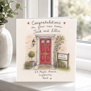 May include: A square greeting card featuring a hand-drawn illustration of a brick house entrance with a red door, a black lantern, and potted plants. The text reads: Congratulations on your new home Jack and Ellie, 23 Maple Avenue, Leybourne, Kent.