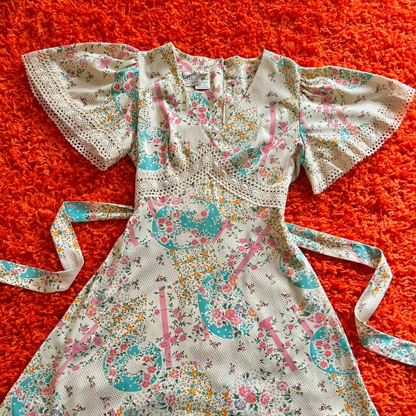 Dreamy 1970s flutter sleeve babydoll mini dress // XS  // 60s 70s Spring floral empire waist mini crochet peek a book cut out trim