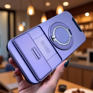May include: A purple smartphone case featuring a sliding camera cover and a circular metal ring stand on the back. The sliding panel is embossed with the text DISCOVER INNOVATION. The case has a matte finish and a sleek, functional design.