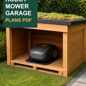 May include: A wooden robot mower garage with a green roof, featuring a dark gray robotic lawn mower parked inside on a black mat. The image includes a dark green overlay with the white and yellow text ROBOT MOWER GARAGE PLANS PDF.