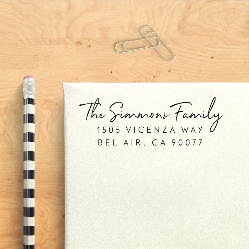 May include: A white envelope with a black return address label that reads "The Simmons Family, 1505 Vicenza Way, Bel Air, CA 90077".