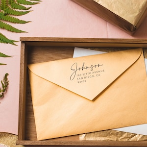 May include: A brown envelope with a return address label that reads "Johnson, 789 Sixth Avenue, San Diego, CA 92102".