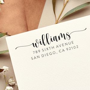 May include: A white card with black text that reads "williams" in cursive, followed by the address "789 Sixth Avenue, San Diego, CA 92102".