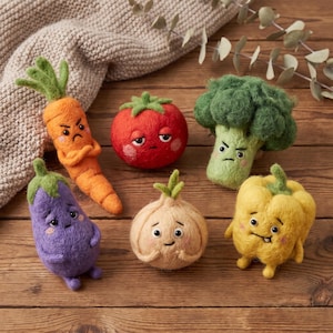 May include: A collection of six needle-felted vegetable figures including an orange carrot, a red tomato, a green broccoli, a purple eggplant, a beige onion, and a yellow bell pepper, each featuring embroidered facial expressions and small arms.