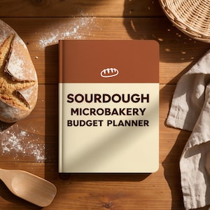 May include: A rectangular planner with a two-tone cover featuring a dark brown top section with a white bread icon and a cream-colored bottom section. The text SOURDOUGH MICROBAKERY BUDGET PLANNER is printed in dark brown capital letters on the cover.