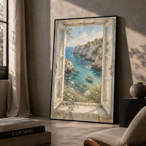 May include: A framed vertical wall art print depicting an open, weathered white wooden window frame looking out onto a coastal scene with a small boat floating on turquoise water, surrounded by rocky cliffs, green vegetation, and a blue sky.