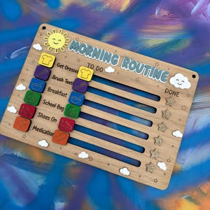 May include: A wooden morning routine checklist board featuring the text "MORNING ROUTINE" and "TO DO" and "DONE". It includes sliding icons for tasks like getting dressed, brushing teeth, breakfast, school bag, shoes on, and medication.
