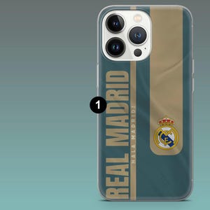 May include: A teal and gold smartphone case featuring the text REAL MADRID and HALA MADRID! vertically aligned. The design includes the official Real Madrid crest with a crown, blue, and gold colors, set against a dark teal background.