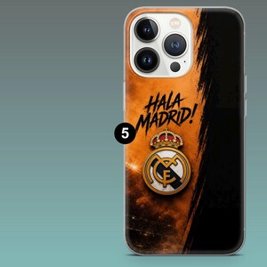 May include: A smartphone case featuring a black and orange gradient background with a brushstroke effect. The text HALA MADRID! is printed in black above the Real Madrid football club crest, which displays a gold crown and a circular logo.