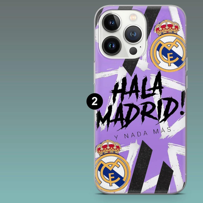May include: A phone case featuring a light purple background with white and black brushstroke patterns. The design includes the Real Madrid club crest and the text HALA MADRID! Y NADA M&Aacute;S in black lettering. The case has a cutout for the camera.