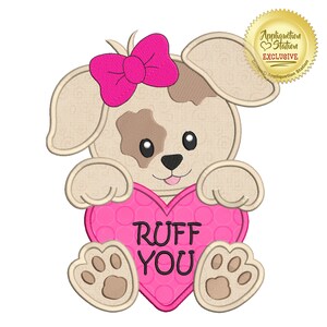 May include: A brown and white puppy wearing a pink bow holds a pink heart-shaped sign that says "RUFF YOU".