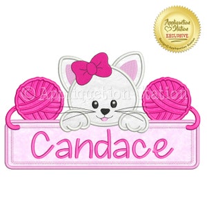 May include: Embroidered design featuring a white cat with a pink bow, peeking over a pink banner with the name "Candace" and two pink yarn balls on either side.
