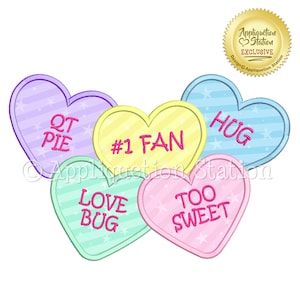 May include: Five colorful heart-shaped candy conversation hearts with different messages. The hearts are arranged in a cluster. The messages on the hearts are "QT PIE", "#1 FAN", "HUG", "LOVE BUG", and "TOO SWEET".