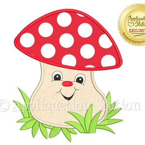 May include: A red and white mushroom with a smiling face and green grass. The mushroom has white polka dots on the top. The text "Appliquetion Station" is on the bottom of the image.