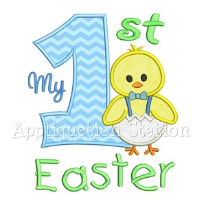 May include: My 1st Easter embroidery design featuring a blue chevron number one, a yellow chick wearing a blue bow tie and a white eggshell, and the text "My 1st Easter".