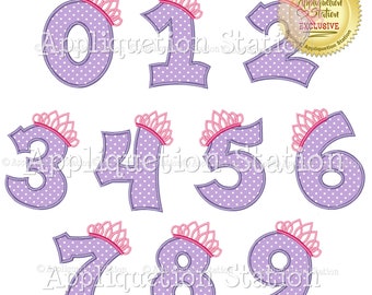 May include: Purple numbers 0-9 with pink crowns on top. Each number has white polka dots. The numbers are in a white background.