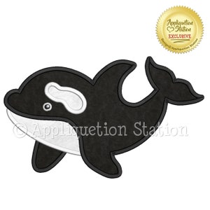 May include: Black and white applique design of an orca whale. The design is outlined in black and has a white eye and a white patch on the back. The design is from Appliquetion Station.