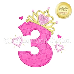 May include: Pink number three with a gold crown and pink hearts. The number has a polka dot pattern. The crown has a pink heart with glitter.