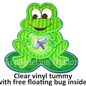 May include: Green frog applique with a clear vinyl tummy and a free-floating bug inside. The frog has a striped pattern and a big smile.