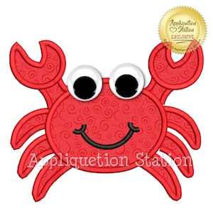 May include: Red embroidered applique design of a smiling crab with large white eyes. The crab has a swirl pattern on its body and is outlined in black thread. The text "Appliquetion Station" is visible below the crab.