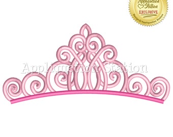 May include: A pink tiara with a decorative, swirling design. The tiara has a curved base and a series of elegant swirls and loops. The text "Appliquation Station" is visible on the tiara. A gold seal with the text "Appliquation Station Exclusive" is in the upper right corner.