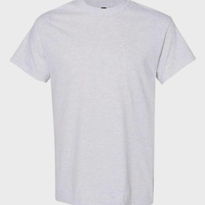May include: A short-sleeved t-shirt in a light heather gray color. The garment features a classic crew neckline, straight hemline, and a solid, speckled fabric texture throughout the entire piece, providing a simple and clean appearance.