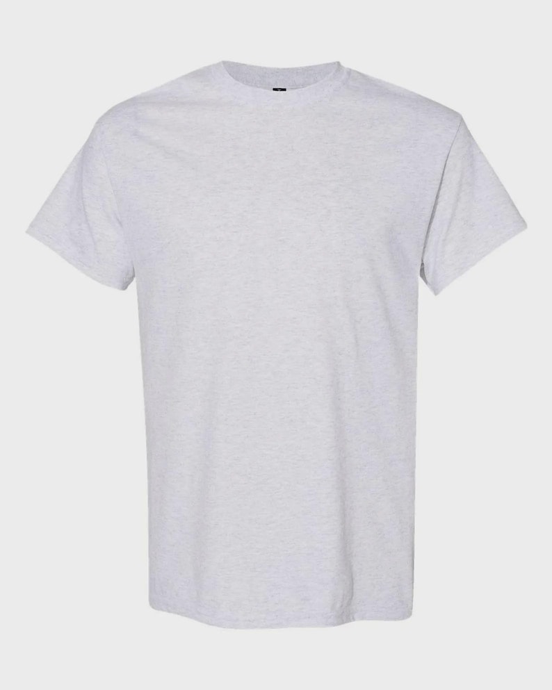 May include: A short-sleeved t-shirt in a light heather gray color. The garment features a classic crew neckline, straight hemline, and a solid, speckled fabric texture throughout the entire piece, providing a simple and clean appearance.