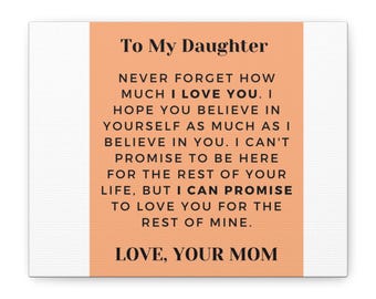 May include: A rectangular wall art piece with a peach-coloured centre panel and white borders. The text reads: To My Daughter, NEVER FORGET HOW MUCH I LOVE YOU. I HOPE YOU BELIEVE IN YOURSELF AS MUCH AS I BELIEVE IN YOU. LOVE, YOUR MOM.