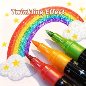 May include: Three markers with red, orange, and green tips positioned in front of a rainbow illustration with the text Twinkling Effect. The black marker barrels feature small star patterns, and the rainbow has a glittery texture.