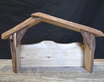 Peut inclure: Une crèche de Noël rustique en bois avec une base rectangulaire simple et un toit incliné en bois vieilli.