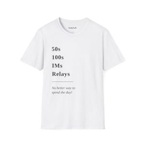 May include: A white short-sleeved t-shirt featuring black text that reads 50s, 100s, IMs, Relays, followed by a horizontal line and the phrase No better way to spend the day! The inner collar label displays the brand name Swim Lyfe in black text.