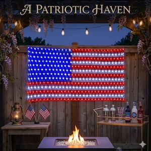 May include: A rectangular LED light display shaped like the American flag, featuring red, white, and blue lights arranged in a grid. The display is mounted on a wooden fence above a fire pit, with the text A PATRIOTIC HAVEN visible above.