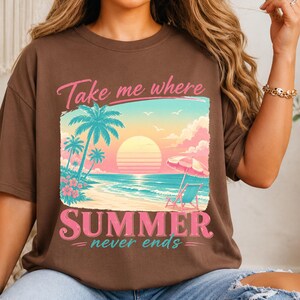May include: A brown short-sleeve t-shirt featuring a graphic of a beach scene with palm trees, a sun, and a beach chair under an umbrella. The text "Take me where SUMMER never ends" is printed in pink and teal above and below the illustration.