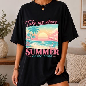 May include: A black t-shirt featuring a graphic print of a tropical beach scene at sunset with palm trees, a beach chair, and an umbrella. The text reads Take me where SUMMER never ends in pink and white lettering across the center of the shirt.