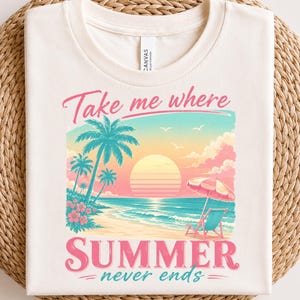 May include: A cream-colored t-shirt featuring a graphic of a tropical beach at sunset with palm trees, a beach chair, and an umbrella. The text reads "Take me where SUMMER never ends" in pink and teal script and block lettering.
