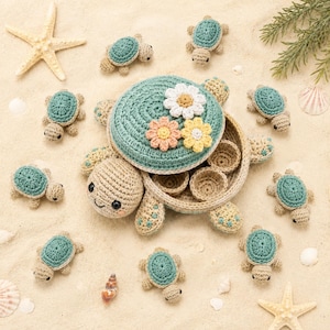 May include: A large crocheted turtle-shaped container with a removable lid decorated with three fabric flowers, surrounded by ten small crocheted turtles, a starfish, and seashells. The container is beige and teal with a circular opening.