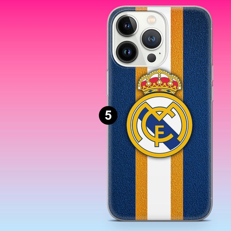 May include: A smartphone case featuring a vertical striped pattern in dark blue, gold, and white. Centered on the case is a circular emblem with a blue diagonal stripe, the letters MCF, and a detailed crown graphic in red, gold, and white colors.
