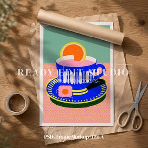 May include: A digital art print featuring a blue teacup and saucer with a pink liquid and an orange slice on top. The background is split between a teal upper section and a pink dotted lower section. The text READY EDIT STUDIO is visible.