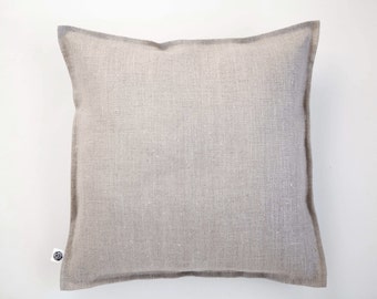 May include: A plain, light gray linen pillow with a subtle texture. The pillow has a simple, understated design and is made from natural materials.
