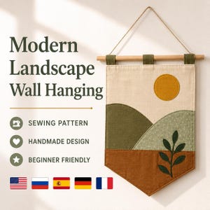 May include: A fabric wall hanging featuring a landscape design with a mustard yellow sun, olive green hills, and a brown base with a dark green leaf sprig. The banner hangs from a wooden dowel with a string and includes the text Modern Landscape Wall Hanging.