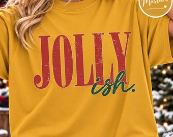May include: A mustard yellow short-sleeved t-shirt featuring the text JOLLY in large, distressed red capital letters and the word ish in a smaller, dark green cursive font. A circular badge in the top right corner says Mustard.