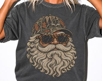 May include: A charcoal gray short-sleeve t-shirt featuring a graphic print of a bearded figure wearing a camouflage baseball cap with oak leaves and leopard print sunglasses. The illustration shows a detailed, flowing beard and mustache.