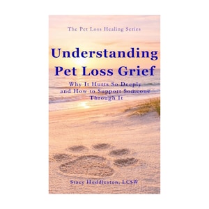 May include: A book titled Understanding Pet Loss Grief: Why It Hurts So Deeply and How to Support Someone Through It by Stacy Huddleston, LCSW. The cover features a paw print in the sand on a beach at sunset, part of The Pet Loss Healing Series.