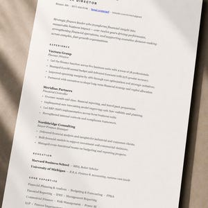 May include: A professional resume document for Michal Grant, Finance Director, featuring contact details, a summary, experience at Vectora Group, Meridian Partners, and Northbridge Consulting, education from Harvard and Michigan, and core expertise.