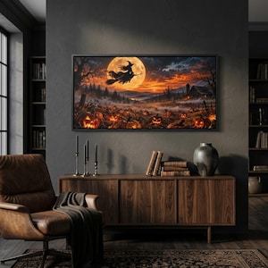 May include: A rectangular wall art print featuring a silhouette of a witch flying on a broomstick against a large full moon. The scene depicts a pumpkin patch at dusk with glowing jack-o'-lanterns, a rustic barn, and a dark, misty landscape.